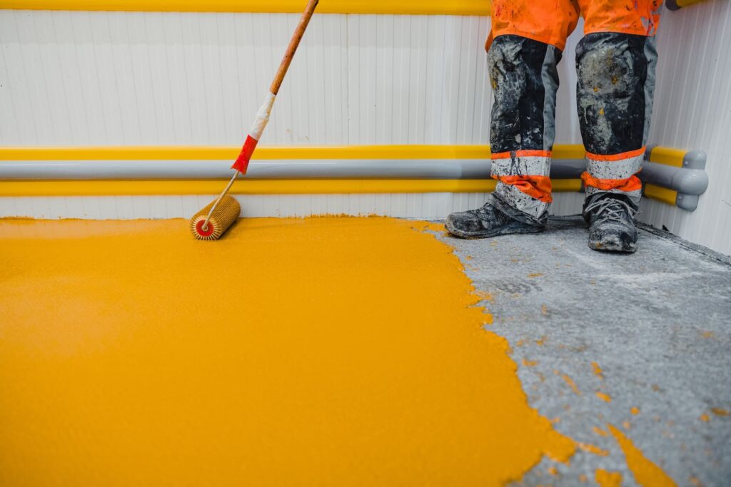 Worker Applying An Epoxy Floor Coating System