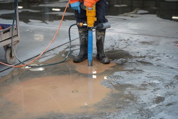 Operator Removing An Anchor From The Pavement